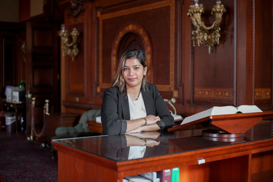 An Archer Fellow poses in the Library of Congress
