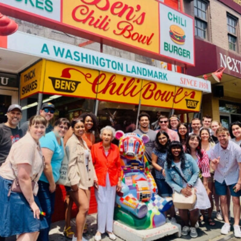 A group of Archer Fellows pose in front of Ben's Chili Bowl restaurant